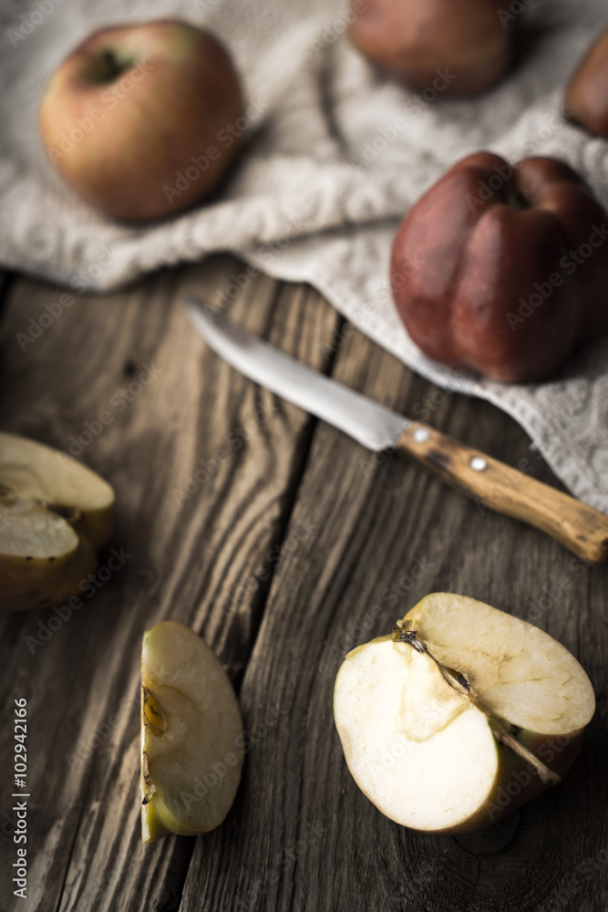 Red apples and apple halves on a wooden table Red apples and apple halves on a wooden table