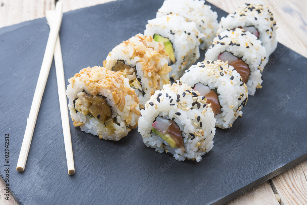 Sushi rolls on a slate plate Sushi rolls on a slate plate