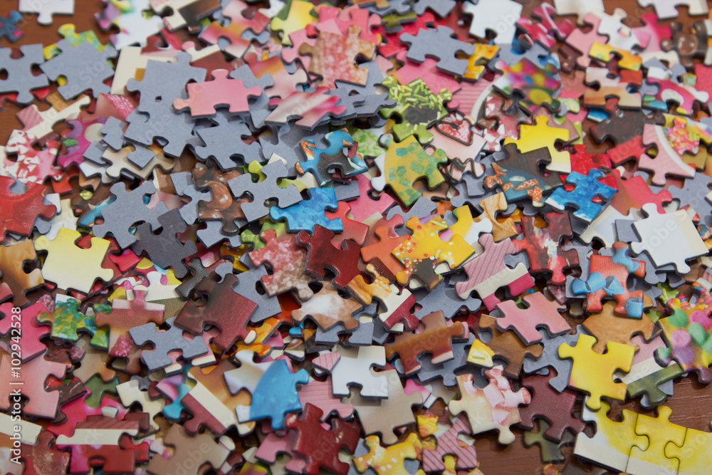 colorful jigsaw puzzle on the desk colorful jigsaw puzzle on the desk