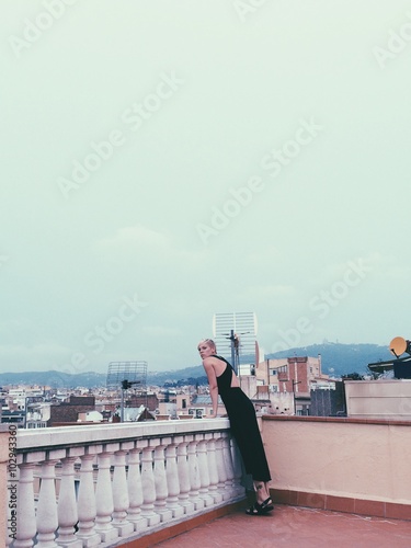 Photography Woman outdoor on balcony look at the city view in Barcelona