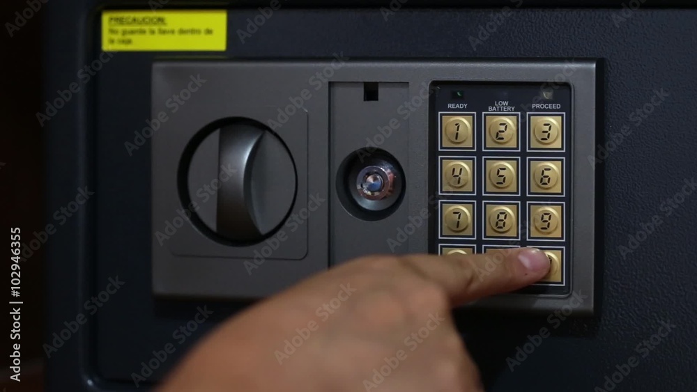 Male hand pushing security code and putting money and passports in safety box and then showing thungs up Male hand pushing security code and putting money and passports in safety box and then showing thungs up