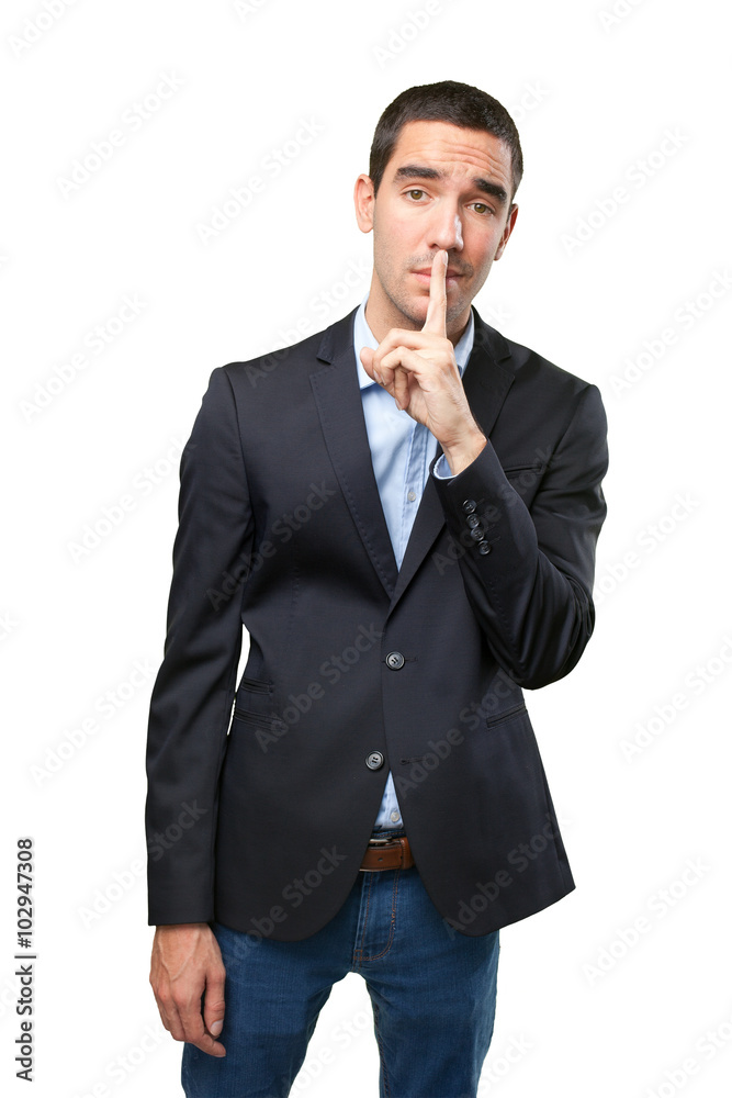 Serious businessman with silence gesture Serious businessman with silence gesture
