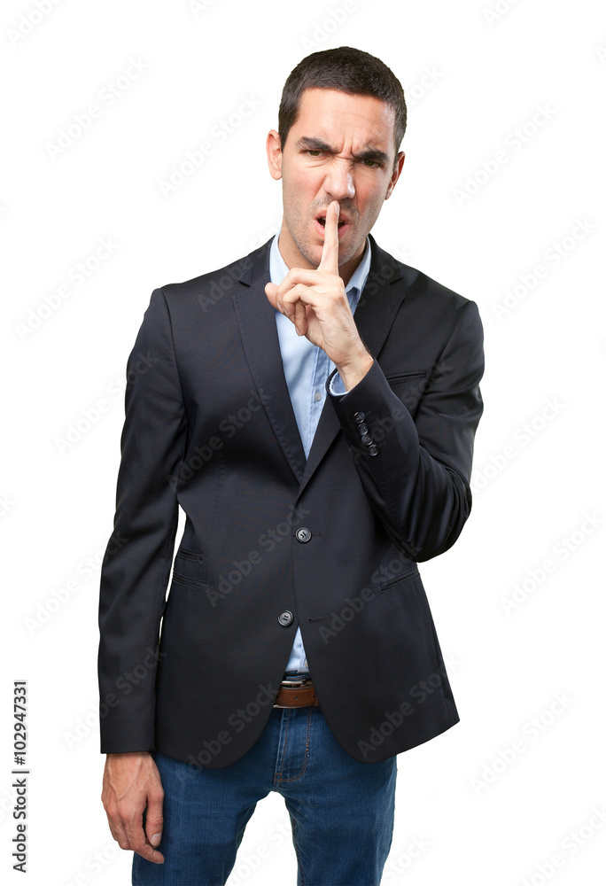 Upset businessman with silence gesture Upset businessman with silence gesture
