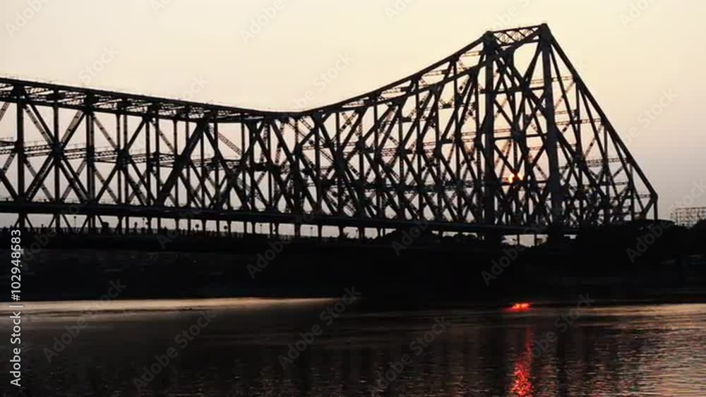 Time lapse shot of the Howrah Bridge over Hooghly River at dusk, Kolkata, West Bengal, India