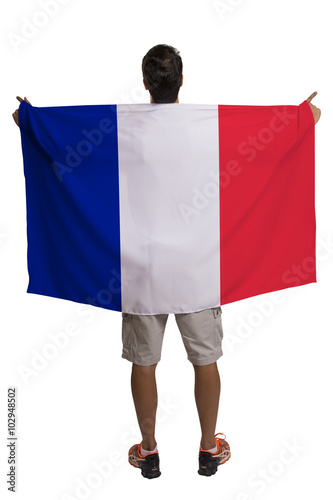 Fan holding the flag of France celebrates on white background