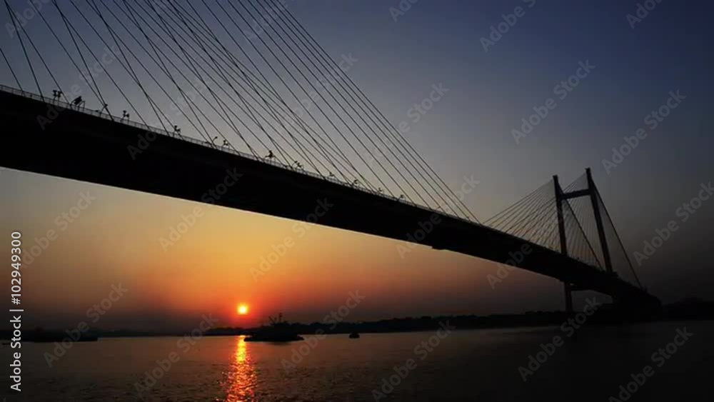 Time lapse shot of the Vidyasagar Setu over Hooghly River at dusk, Kolkata, West Bengal, India Time lapse shot of the Vidyasagar Setu over Hooghly River at dusk, Kolkata, West Bengal, India