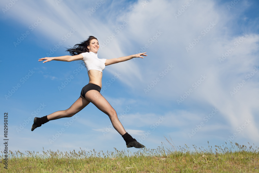 Attractive young woman jumping on open air Attractive young woman jumping on open air