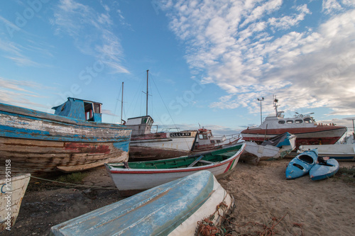 View of many traditional fishing boats anchored on low tide near Santa Luzia village  Portugal.