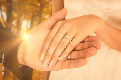 Composite image of newly wed couple holding hands