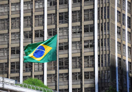 Brazilian flag with building in background