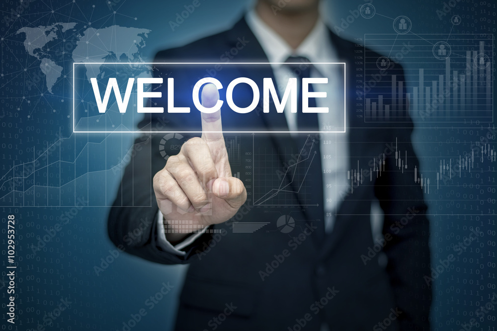 Businessman hand touching WELCOME button on virtual screen Businessman hand touching WELCOME button on virtual screen