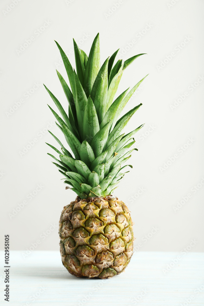 Ripe pineapple on a white wooden table Ripe pineapple on a white wooden table