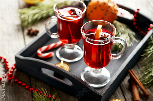 Mulled wine in glass on grey wooden table