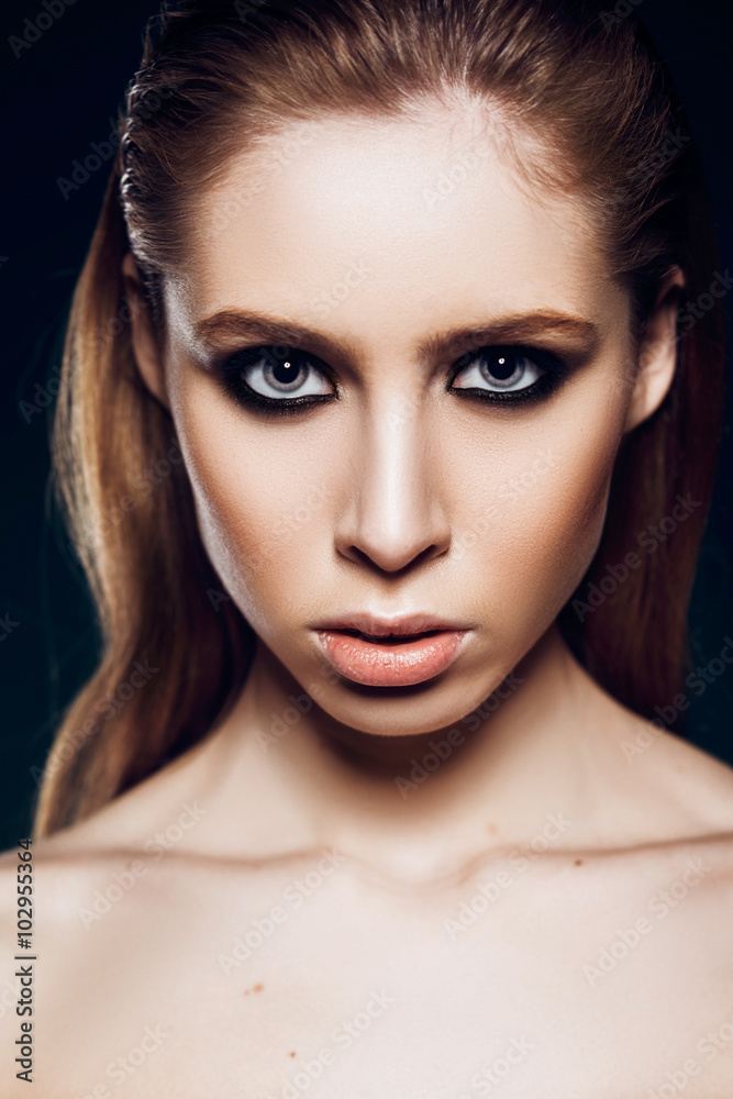 beautiful girl model with smoky eye makeup in the studio on a background of a portrait beautiful girl model with smoky eye makeup in the studio on a background of a portrait