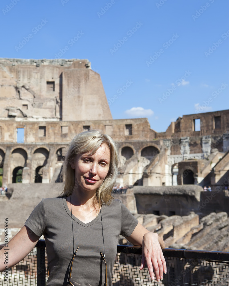 Italy. Rome. The  woman tourist on ruins of the ancient Collosseo