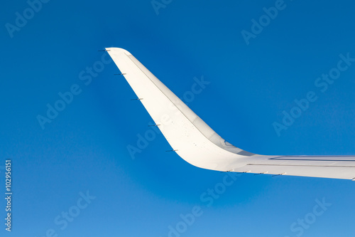 wing of aircraft under blue sky