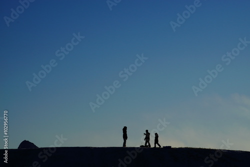 People on a hill top.