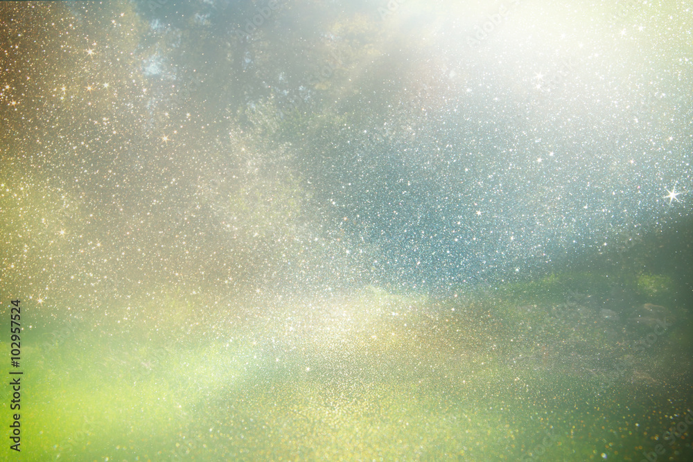 Fototapeta premium abstract photo of light burst among blurry landscape and glitter bokeh lights. image is blurred and filtered . 
