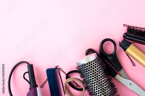 Hairdressing tools on a pink background