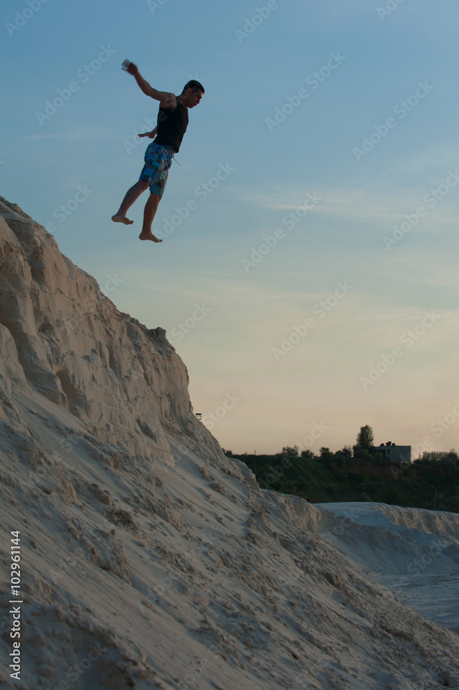 man in a jump on the beach