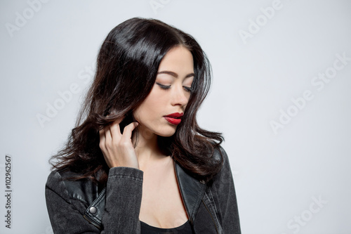 Fashion model woman with dark red lips in studio