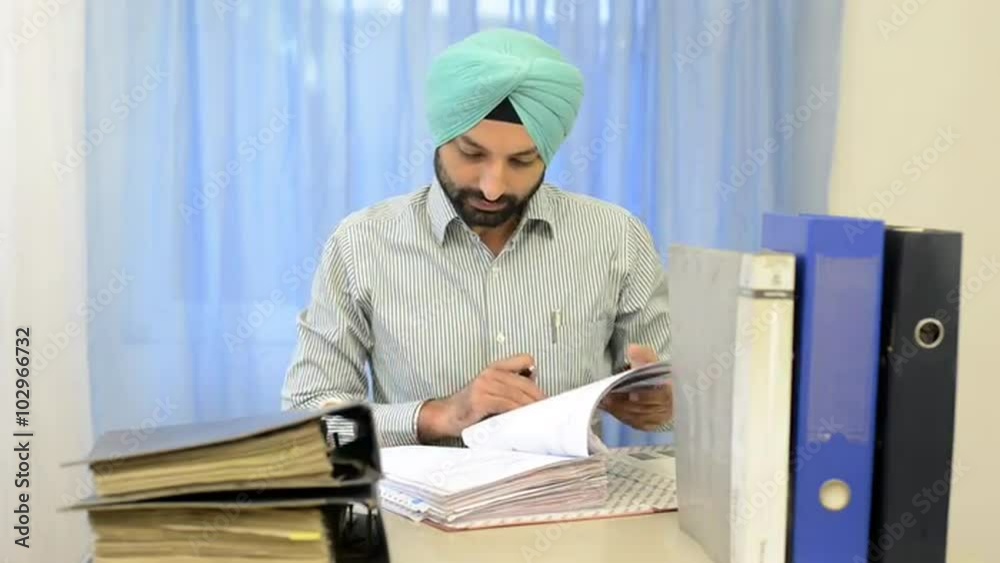 Locked-on shot of a businessman working in a office Locked-on shot of a businessman working in a office