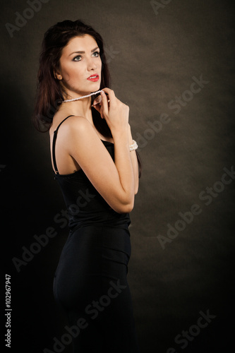 woman in sensual black dress on dark