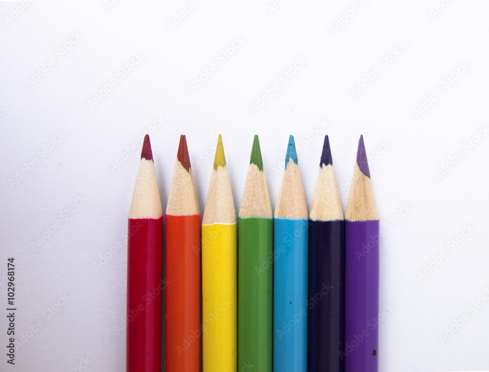 Rainbow of colored pencils, white background, view from the top Rainbow of colored pencils, white background, view from the top