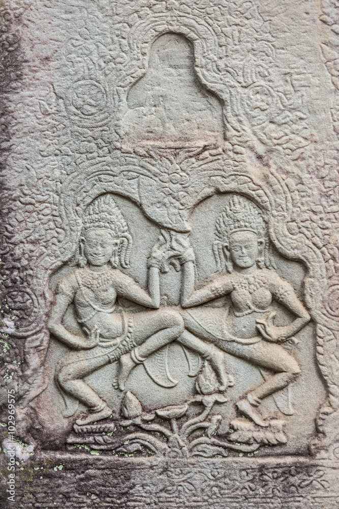 Historic Khmer bas-relief showing dancing Hindu godesses at Bayon temple, Cambodia