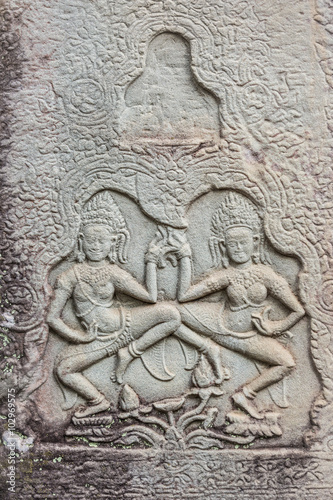 Historic Khmer bas-relief showing dancing Hindu godesses at Bayon temple, Cambodia