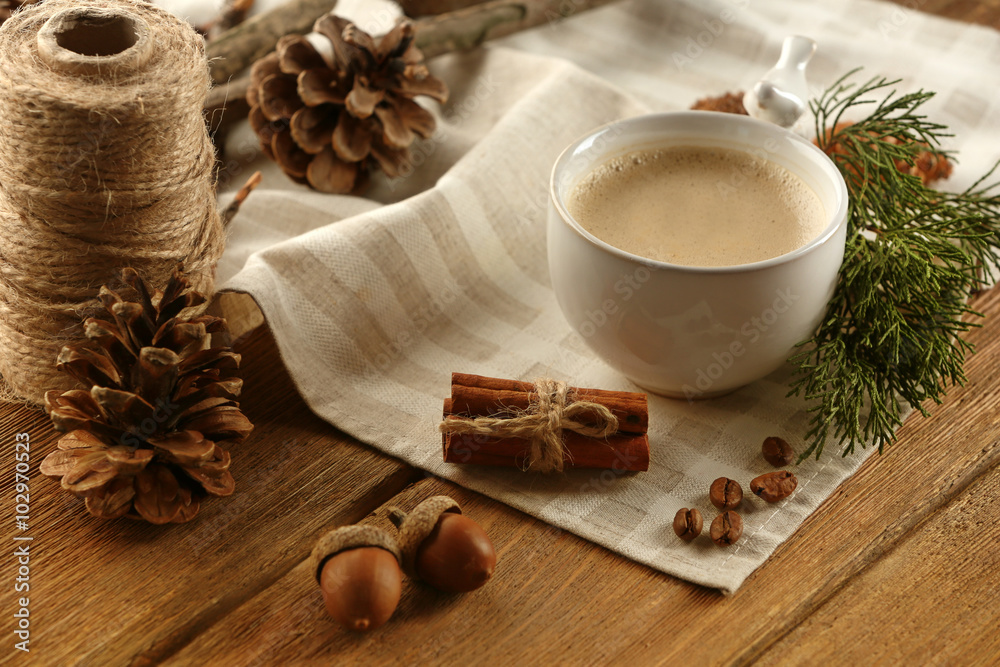Cup of coffee on napkin on wooden background Cup of coffee on napkin on wooden background