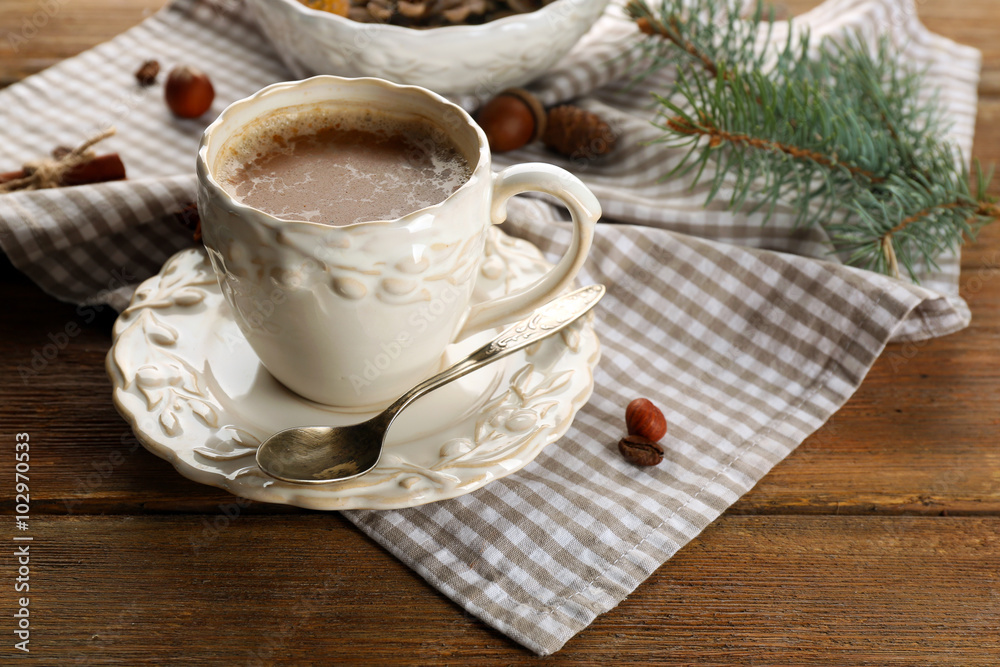Cup of coffee and Christmas tree branch on napkin Cup of coffee and Christmas tree branch on napkin
