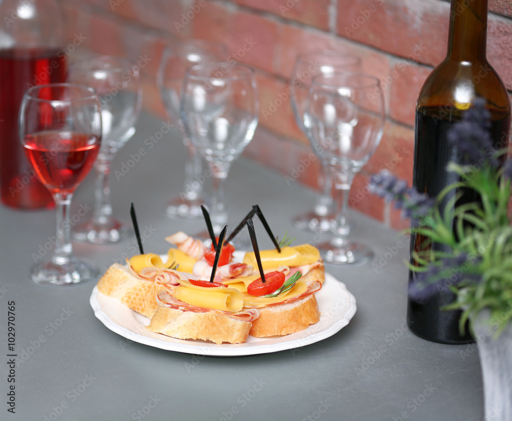 Delicious canape and wine on the kitchen table, close up