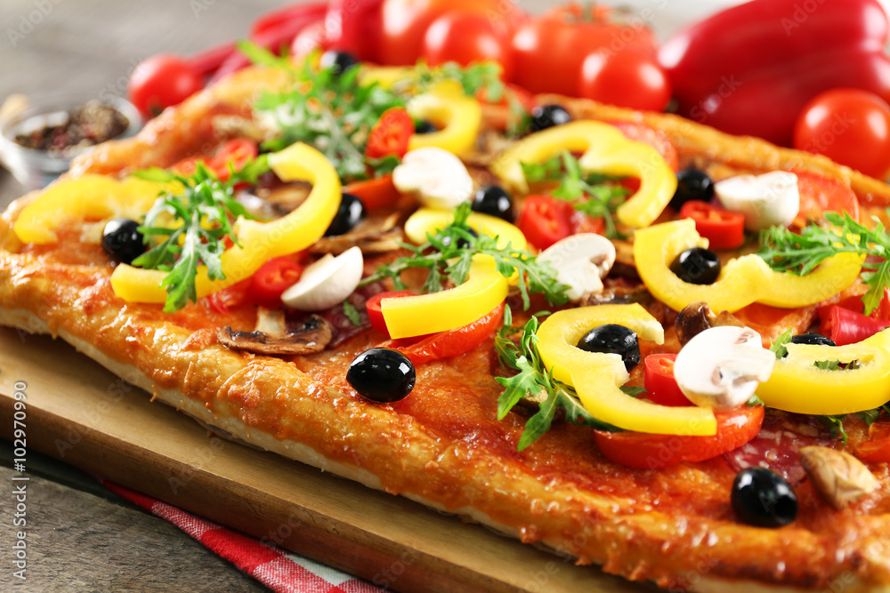 Delicious rectangle pizza on the table, close-up