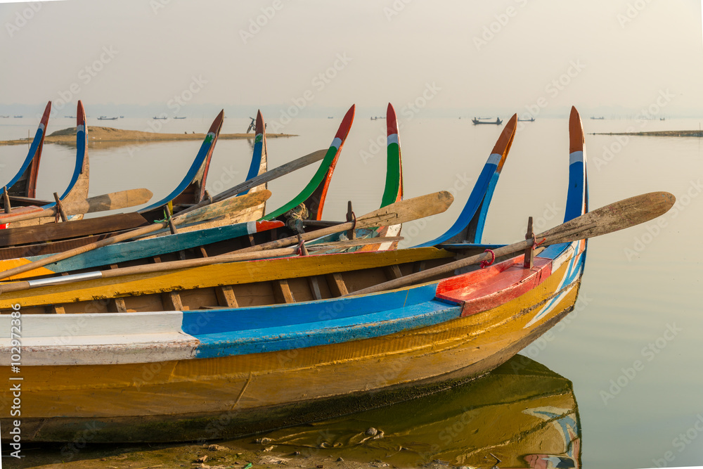 Fishing boat in sunrise at U Bein bridge, Mandalay, Myanmar