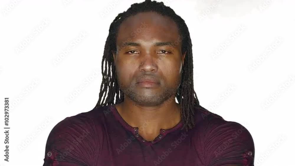 Serious man crosses his arms and stares, on a white studio background Serious man crosses his arms and stares, on a white studio background