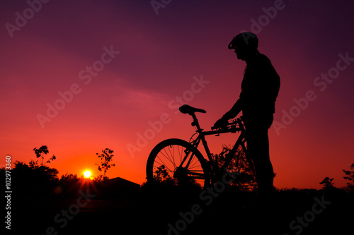 Fototapeta Naklejka Na Ścianę i Meble -  A silhouette of biker at sunset