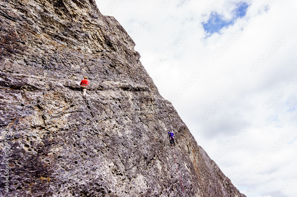 Climbers practicing their rock climbing skills on the Steep Rock Walls of the mountains at the Grassi Lakes near Canmore in the Canadian Rockies Climbers practicing their rock climbing skills on the Steep Rock Walls of the mountains at the Grassi Lakes near Canmore in the Canadian Rockies