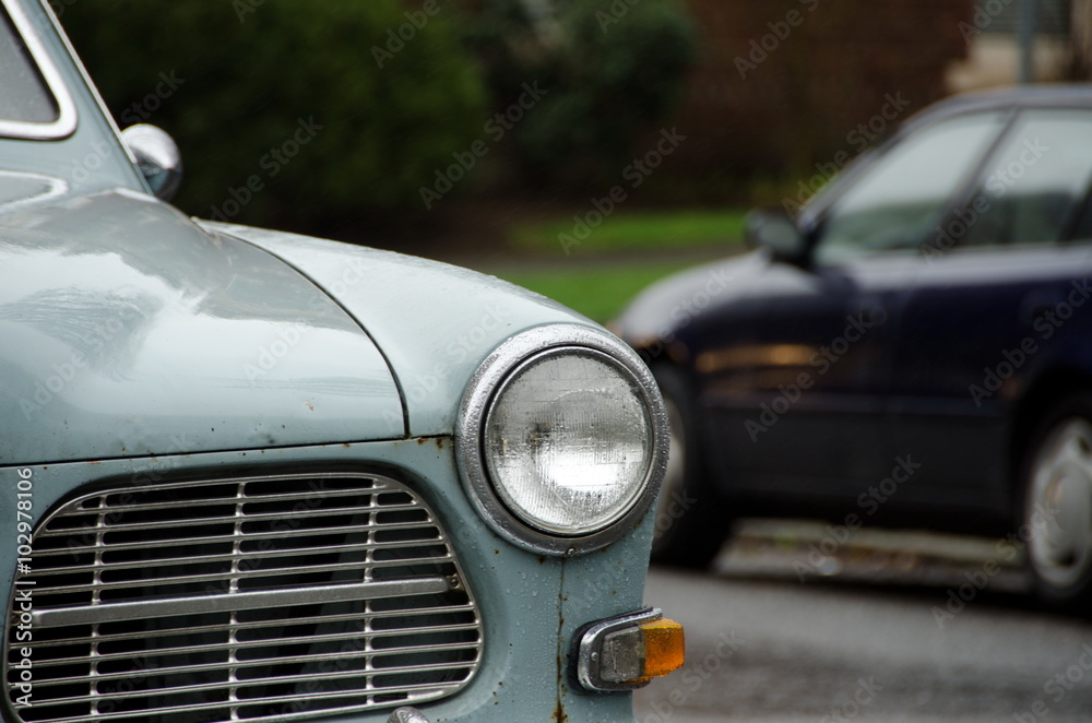 Classic and modern cars parked under rain on Queen Ann hill, Sea
