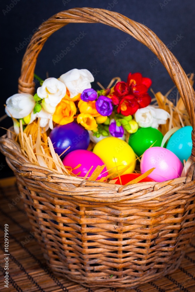 Easter eggs and freesia in basket Easter eggs and freesia in basket