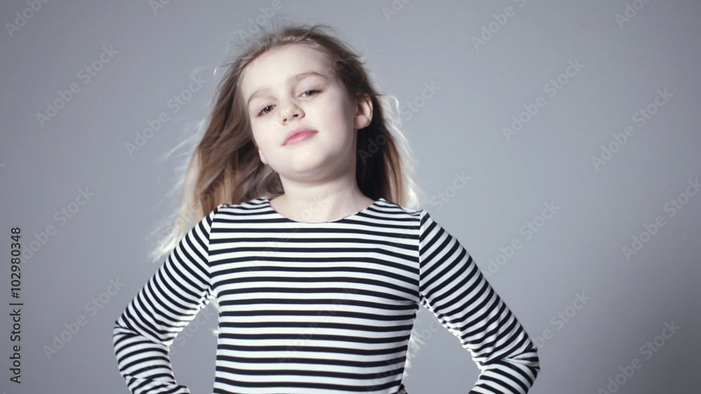 Portrait of beautiful child girl model with long hair posing in studio. Beautiful eight years old girl laughing over grey background. Portrait of beautiful child girl model with long hair posing in studio. Beautiful eight years old girl laughing over grey background.