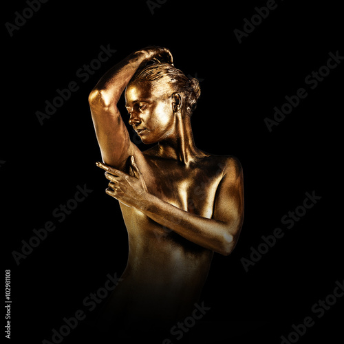Fotografie Young woman with golden skin