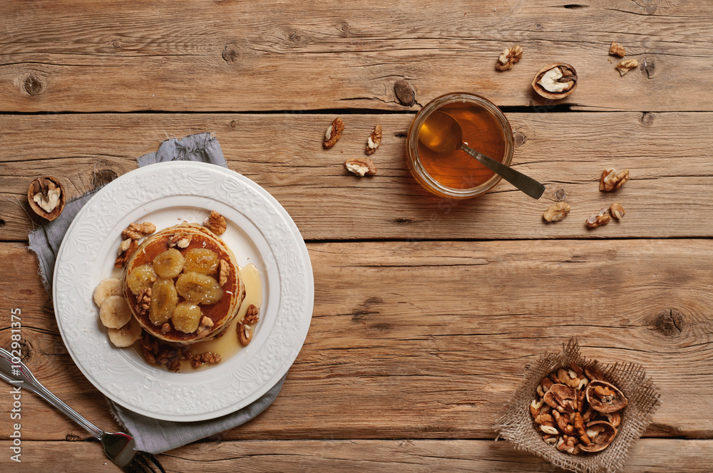 healthy breakfast of pancakes with honey, nuts and caramelized b