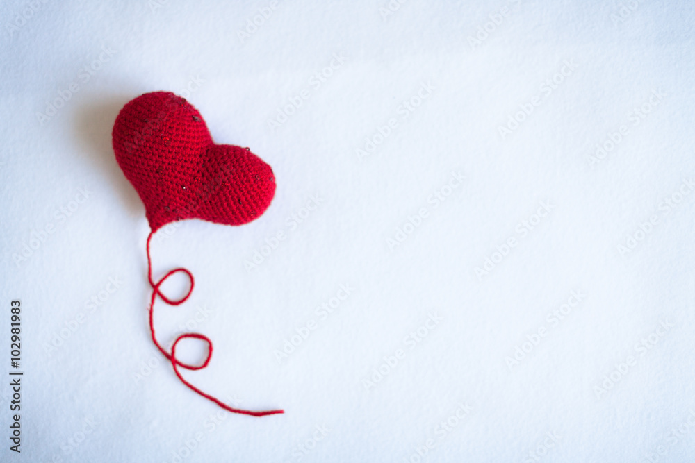 Fototapeta premium red knitted heart knitted white background knitting,