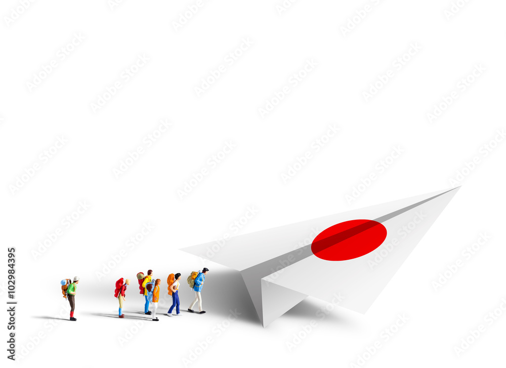 Fototapeta premium Miniature backpackers walking to the paper germany airplane on w