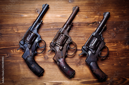 Vintage pistols on wooden background