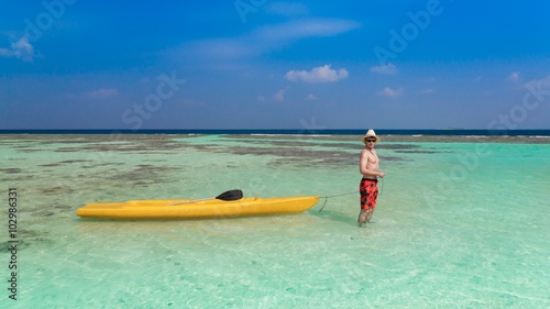 Maldives, with yellow canoe