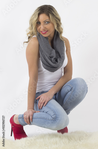 Beautiful young woman posing in studio on white background