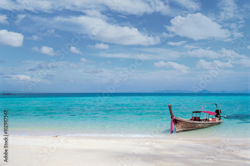 A boat on the clear beach. 