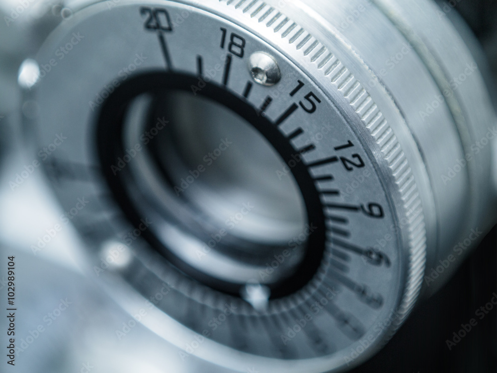 Photograph of a dial on a phoropter in an eye doctor's office. The dial is seen in close up with shallow depth of focus.